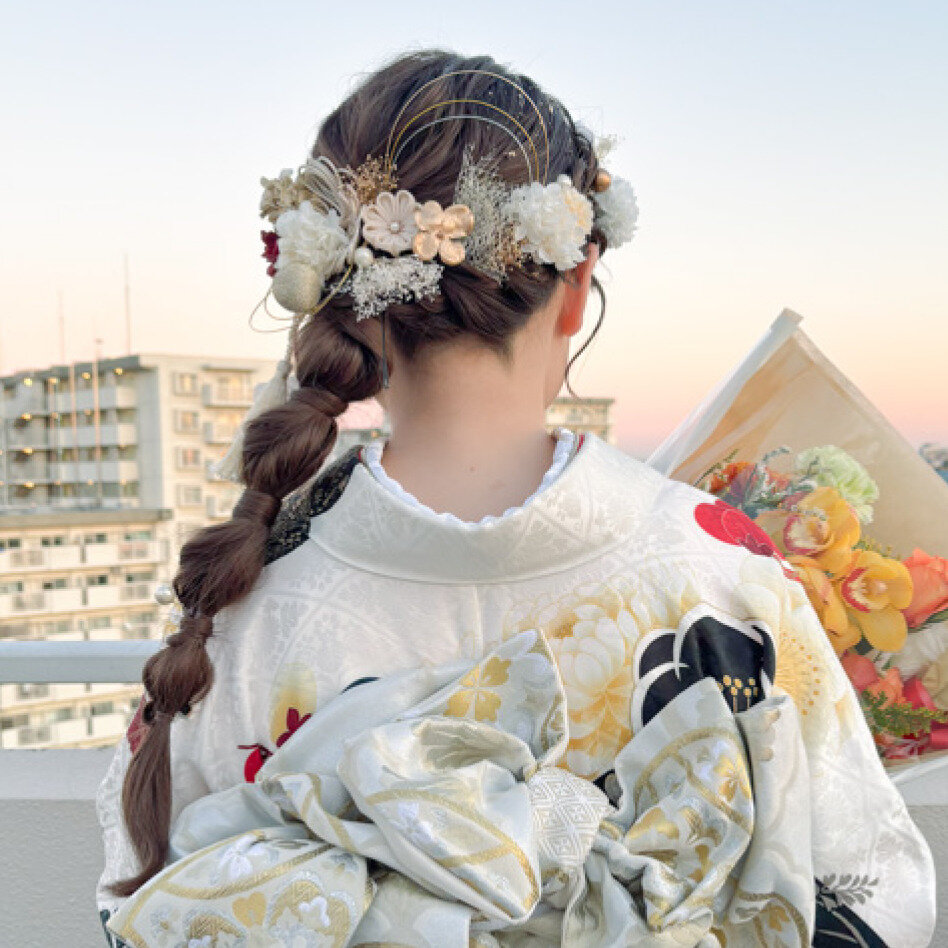 うなじ周りの編み込み部分に沿わせたお花のアクセで、華やかさが一気に出るスタイル。